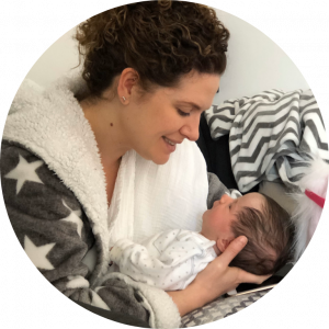 Doula Jess holding and smiling at a new born baby